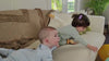 babies sitting on couch playing